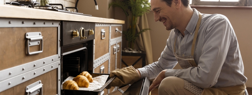 medium-shot-man-holding-tray-with-croissants